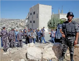  ?? Reuters ?? Security forces gather near a damaged building in the city of Salt, Jordan. —