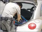  ?? Myung J. Chun Los Angeles Times ?? L.A. COUNTY Deputy John Leitelt searches a car in a traffic stop on the 5 Freeway north of Santa Clarita.