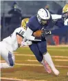  ?? STEVE JOHNSTON/ DAILY SOUTHTOWN ?? Hillcrest’s Elijawah Tolbert pushes forward for extra yards after his catch in front of Lemont’s Cole Brannigan during Friday’s game.