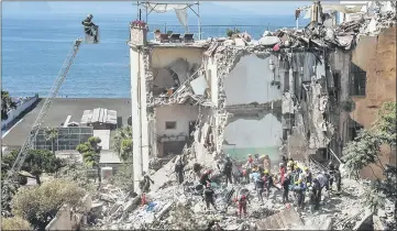  ??  ?? Firefighte­rs search the rubble after two floors collapsed in a small four-storey building in Torre Annunziata, in a town near the Italian city of Naples. — AFP photo