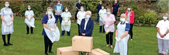  ??  ?? Special delivery: Essential Mail Force protective gear is welcomed by staff at the Presentati­on Sisters Care Centre, Derbyshire