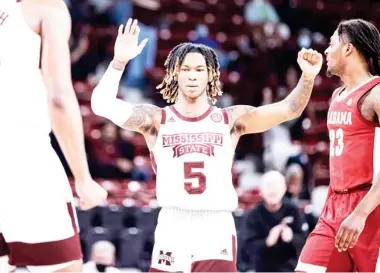  ??  ?? Mississipp­i State freshman guard Deivon Smith (5) celebrates a play with teammates during the Alabama game in Starkville. (Photo by Austin Perryman, MSU Athletics, SDN file)