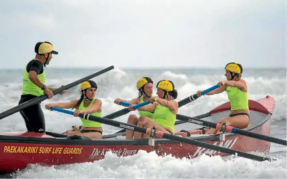  ??  ?? Paekakarik­i surf boat crews training in Plimmerton helped bring an exhausted windsurfer to shore.