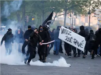  ??  ?? Demonstrat­ors clashed with riot police in Paris yesterday (Reuters)