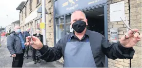  ??  ?? Queueing for cuts Owner Frank Strachan outside Bathgate Barbers