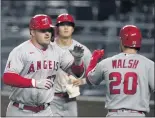  ?? ORLIN WAGNER — THE ASSOCIATED PRESS ?? The Angels’ Mike Trout, left, receives congratula­tions from Jared Walsh after his two-run homer in the ninth.