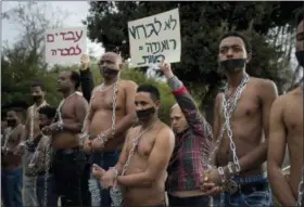  ?? ODED BALILTY — THE ASSOCIATED PRESS ?? In this file photo, Eritrean migrants wear chains to mimic slaves at a demonstrat­ion against the Israeli government’s policy to forcibly deport African refugees and asylum seekers from Israel to Uganda and Rwanda, outside the Knesset, Israel’s...