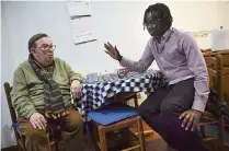  ?? ALVARO BARRIENTOS AP ?? Mbaye Babacar Diouf, right, visits with his adoptive father, Juan Gil, 74, in the basque city of Algorta, northern Spain.