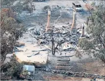  ?? Photo: REUTERS ?? Reduced to ashes: The ruins of one of more than 60 homes destroyed by a bushfire in Dunalley, about 40 kilometres east of Hobart.