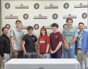  ?? kevin Myrick ?? Students from RHS who are committing to go to the Universal Technical Institute gathered for a photo during a signing day ceremony on May 7.