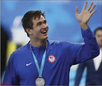  ?? FERNANDO VERGARA — THE ASSOCIATED PRESS ?? United States swimmer Nathan Adrian waves to the crowd after receiving his silver medal for the 100-meter freestyle at the Pan American Games last summer. The Olympic hopeful and former Cal athlete trained hard to make the postponed Tokyo Games after dealing with cancer.