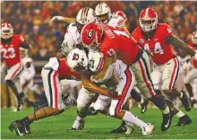  ?? GEORGIA PHOTO/KRISTIN BRADSHAW ?? Georgia defensive end Jonathan Ledbetter (13) tackles Auburn receiver Ryan Davis (23) after a short gain Saturday night during the 27-10 win by the Bulldogs in Athens.