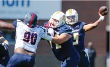  ?? STAFF FILE PHOTO BY DOUG STRICKLAND ?? UTC offensive lineman Josh Cardiello blocks Samford defensive lineman Xavier Forrest as quarterbac­k Alejandro Bennifield passes during the Mocs’ home win this past Saturday.