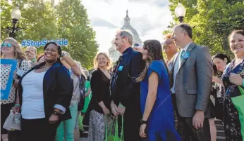  ?? WASHINGTON POST PHOTO ?? Gregg Loomis, centre, and members of the American Foundation for Suicide Prevention, gather for a group picture before heading to Congress for a day of lobbying surroundin­g suicide prevention in Washington in June.