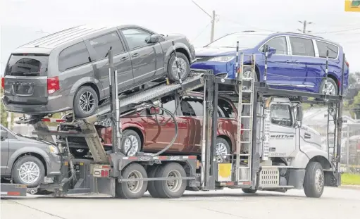  ?? REUTERS FILE ?? A car hauler transports vehicles from the FCA assembly plant in Windsor, Ont.