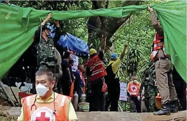  ?? [PHOTO BY CHIANG RAI PUBLIC RELATIONS OFFICE VIA AP] ?? Emergency workers carry a stretcher Sunday with one of the rescued boys to be taken by ambulance to a hospital in Mae Sai, in the district of Chiang Rai, Thailand.