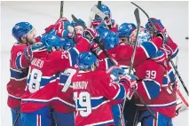  ?? G R A H A M H U G H E S / T H E C A NA D I A N P R E S S ?? Canadiens players celebrate after defeating the Philadelph­ia Flyers in a shootout in Montreal, Friday.