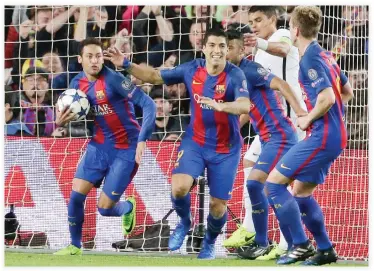  ??  ?? Barcelona’s Neymar, left, and his teammates Luis Suarez and Ivan Rakitic celebrate after PSG’s Layvin Kurzawa scored an own goal during the Champions League round of 16, second leg soccer match between FC Barcelona and Paris Saint Germain at the Camp...