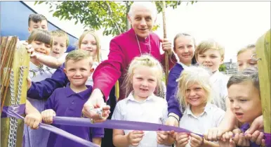  ?? Picture: Andy Jones FM4426928 ?? The Bishop of Dover Rev Trevor Wilmott cutting the ribbon with members of the school council