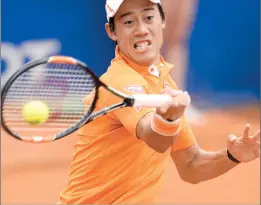  ??  ?? Japan's Kei Nishikori returns the ball to Ukainian Alexandr Dolgopolov during the ATP Barcelona Open "Conde de Godo" tennis tournament in Barcelona. Nishikori won 5-7, 0-6.