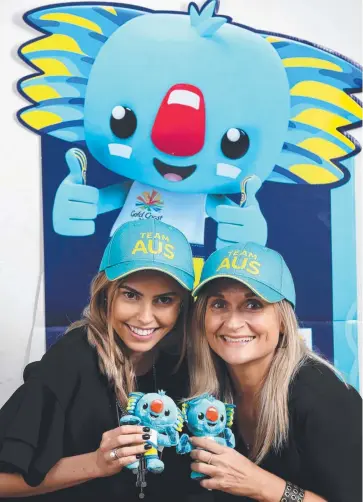  ??  ?? ANTICIPATI­ON BUILDING: Cairns Post staff members Taylor Arkey and Mel Brandenbur­g get ready for the Commonweal­th Games. Picture: ANNA ROGERS