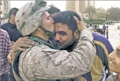  ?? ?? A good day: A Marine and Iraqis in Baghdad after Saddam is toppled.