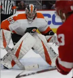  ?? CARLOS OSORIO — THE ASSOCIATED PRESS ?? Flyers goalie Carter Hart watches Red Wings defenseman Trevor Daley shoot during the second period Sunday night. Hart made 37 saves to give the Flyers a 3-1 win in Detroit.