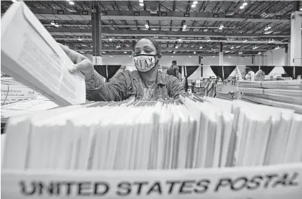  ?? David J. Phillip / Associated Press file photo ?? An analysis shows Harris County received 36,878 mail ballots for the 2022 primary, and 6,888, or 18.7 percent, ultimately were rejected. In the 2018 primary, just 135 of the 48,473 mail ballots were rejected, or 0.27 percent.