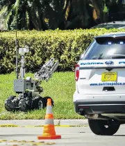  ?? TAIMY ALVAREZ / SOUTH FLORIDA SUN-SENTINEL VIA AP ?? A bomb defusing robot is sent into the building housing U.S. Rep. Debbie Wasserman Schultz’s office in Florida.