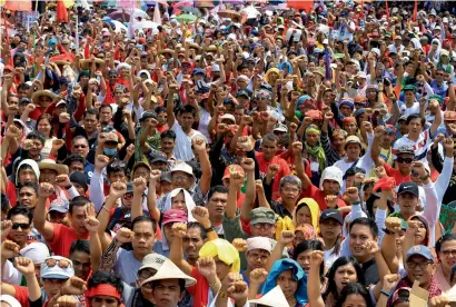  ?? Reuters ?? rodrigo Duterte supporters clench fists during a rally outside the House of representa­tives ahead of Duterte’s first state of the nation address in Quezon city, metro manila, on monday. —