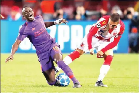  ??  ?? Liverpool midfielder Sadio Mane (left) is fouled during their Champions League Group C match against Red Star at the Rajko Mitic Stadium in Belgrade on Tuesday night.