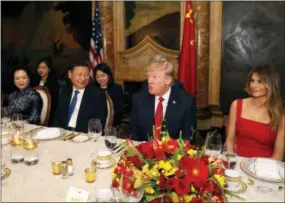  ?? THE ASSOCIATED PRESS ?? President Donald Trump and Chinese President Xi Jinping, with their wives, first lady Melania Trump and Chinese first lady Peng Liyuan, are seated during a dinner at Mar- aLago on Thursday.