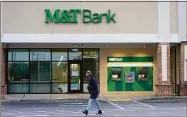  ?? Julio Cortez / Associated Press ?? M&T Bank says it will compensate former People’s customers who lost money after converting to M&T’s computer system.