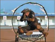  ??  ?? A soldier jumps through a flaming hoop as part of a training exercise in Monrovia.