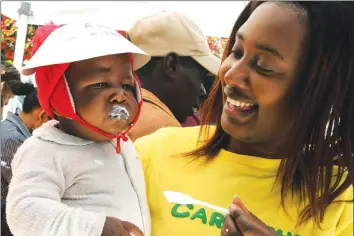  ?? — (Picture by Tawanda Mudimu) ?? Samantha Dumba of Carnethy Dairy feeds John Mpingo with sour milk during World Milk Day commemorat­ions in the Harare Gardens yesterday.