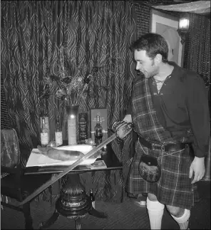  ?? Nick Lees, the journal ?? Andrew Walls gets ready to cut the haggis at the New Asian Village Burns’
Supper commemorat­ing Scottish poet Robert Burns’ Jan. 25 birthday.