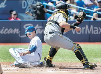  ?? THE CANADIAN PRESS ?? Toronto Blue Jays’ Ryan Goins, crossing home plate against the Pittsburgh Pirates, drove in two runs during Sunday’s 7-1 win at Rogers Centre.