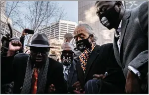  ?? (The New York Times/Joshua Rashaad McFadden) ?? Ben Crump (from left), the attorney for George Floyd’s family, joins with Floyd’s brother Philonise, the Rev. Al Sharpton and Floyd’s nephew Brandon Williams on Monday in Minneapoli­s.