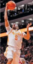  ?? TENNESSEE ATHLETICS PHOTO ?? Tennessee sophomore guard Zakai Zeigler scored the first points of Tuesday night’s 75-57 thumping of Arkansas with this layup but was lost for the season moments later due to a torn left anterior cruciate ligament.