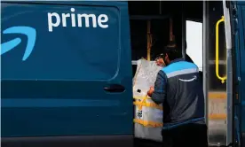  ?? Photograph: Patrick T Fallon/AFP/Getty Images ?? An Amazon delivery driver loads a van outside of a distributi­on facility on 2 February 2021 in Hawthorne, California.