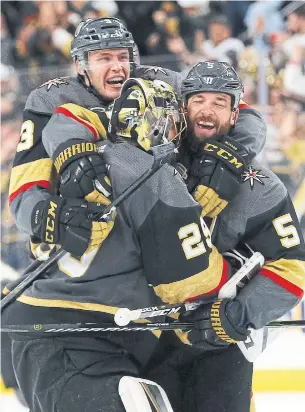  ?? JOHN LOCHER/THE ASSOCIATED PRESS ?? Vegas Golden Knights Brayden McNabb, goaltender Marc-Andre Fleury and Deryk Engelland celebrate after wrapping up Game 2 against the Los Angeles Kings.