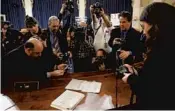  ?? PATRICK SEMANSKY/AP ?? Members of the press view the roll call vote recorded by the clerk after the House Judiciary Committee approved the articles of impeachmen­t against President Trump.