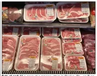  ?? (AP/Matt Rourke) ?? Cuts of pork fill a case at a grocery store in Roslyn, Pa., on Tuesday. Wholesale prices, boosted by rising food costs, increased 0.8% in May, and have climbed by a record amount over the past year.