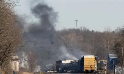  ?? Photograph: Dustin Franz/AFP/Getty Images ?? Smoke rises from the derailed cargo train in East Palestine, Ohio, on Saturday.