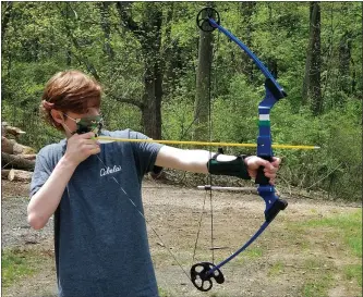  ??  ?? Logan Hartman, 12, of Sinking Spring, draws a bow Sunday at South Mountain YMCA Camp’s Family Fun Day in South Heidelberg Township.
