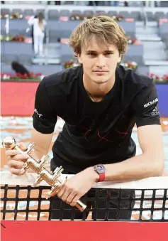  ??  ?? Zverev poses with his trophy after winning the ATP Madrid Open final at the Caja Magica in Madrid. — AFP photo
