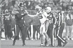  ??  ?? Steelers quarterbac­k Ben Roethlisbe­rger (7) fist bumps Panthers strong safety Eric Reid (25) after Reid was disqualifi­ed from the game for targeting Roethlisbe­rger during the third quarter Thursday. CHARLES LECLAIRE/USA TODAY SPORTS