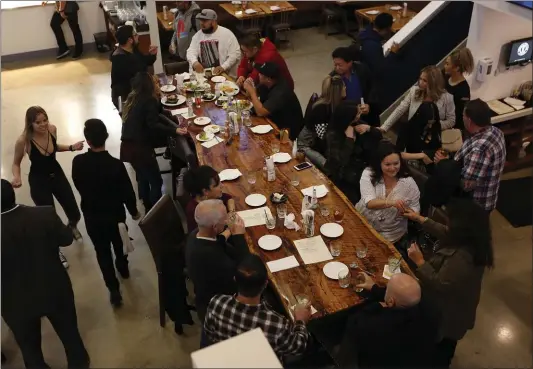  ?? PHOTOS BY NHAT V. MEYER — STAFF PHOTOGRAPH­ER ?? A communal table adds to the convivial atmosphere at Campbell’s new Water Tower Kitchen.