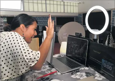  ?? BRITTANY MURRAY — STAFF PHOTOGRAPH­ER ?? Angel Mikaele, a fifth-grade teacher at Dooley Elementary School in Long Beach, teaches her students remotely from an empty classroom in September. After a year of distance learning, the state is pressing for the reopening of schools.