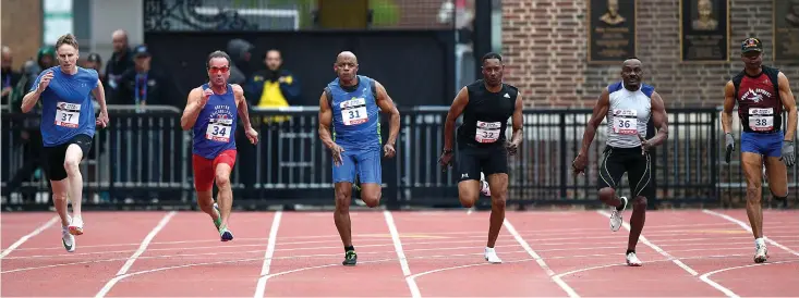  ?? Washington Post photo by Jonathan Newton. ?? Competitor­s take off from the starting line in the masters men's 100-meter dash for age 60 and over.